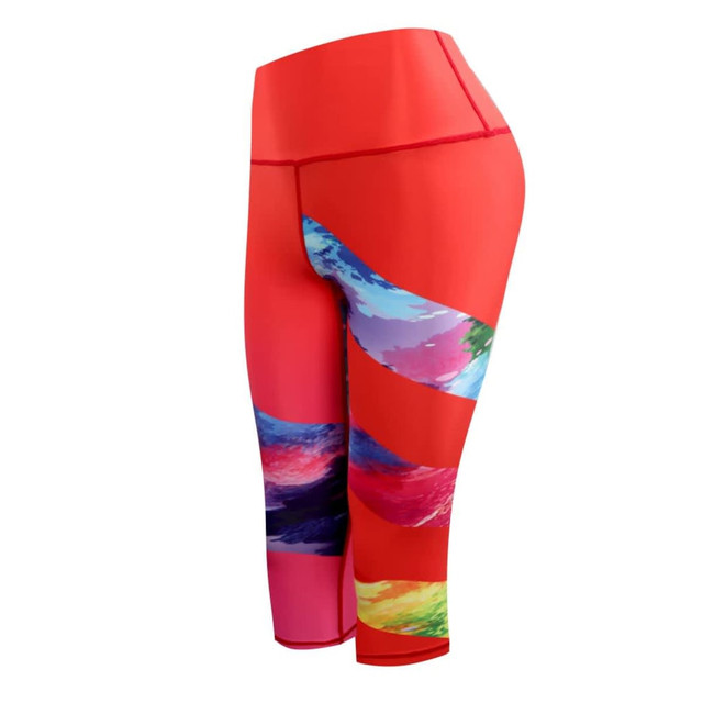 A pair of vibrant red 3/4 pants for ladies, featuring colourful wave patterns on the side and a logo.