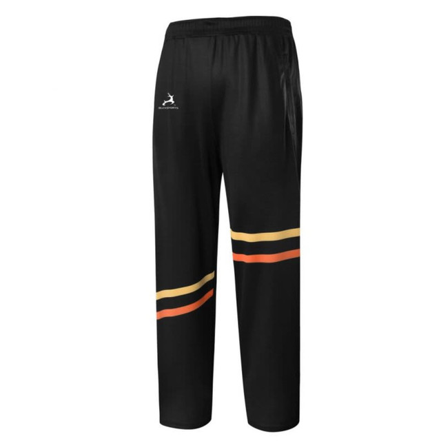 Lawn bowls pants in black with a bold striped design in red, orange, and yellow, featuring a logo.