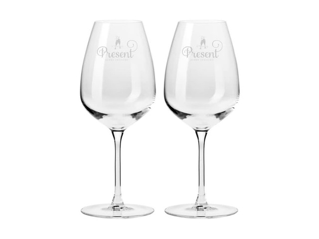 Two clear, elegant wine glasses in a gift box, featuring delicate engraving and showcasing a classic stem design.
