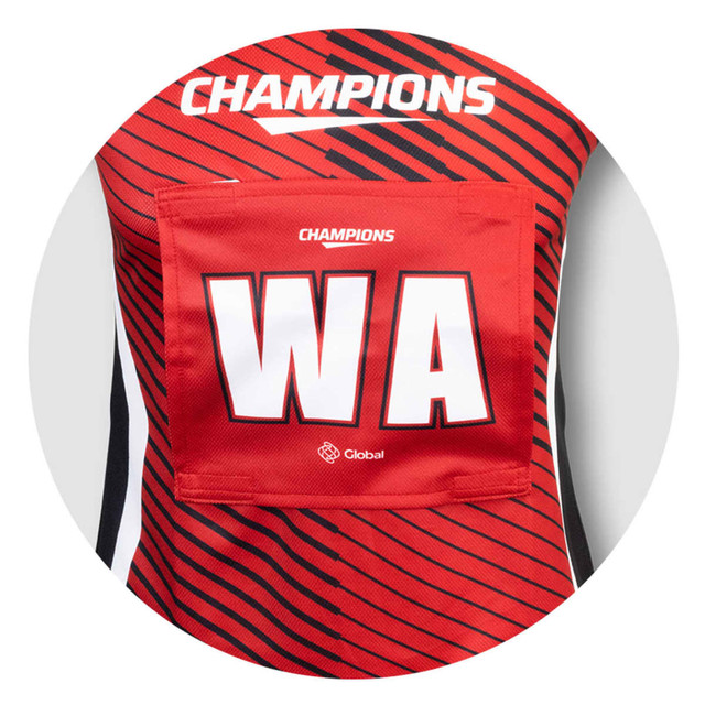 A red netball bib with black stripes, featuring a large white "WA" and a logo.
