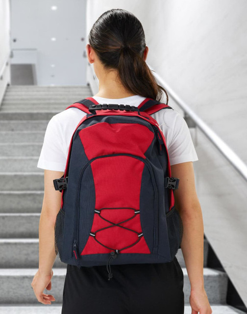 A red and black backpack featuring a mesh side pocket and bungee cord design, with adjustable straps and a logo.