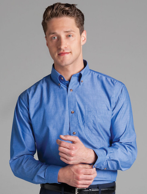 A long-sleeve indigo chambray shirt with a button-up front, featuring a chest pocket and orange buttons.