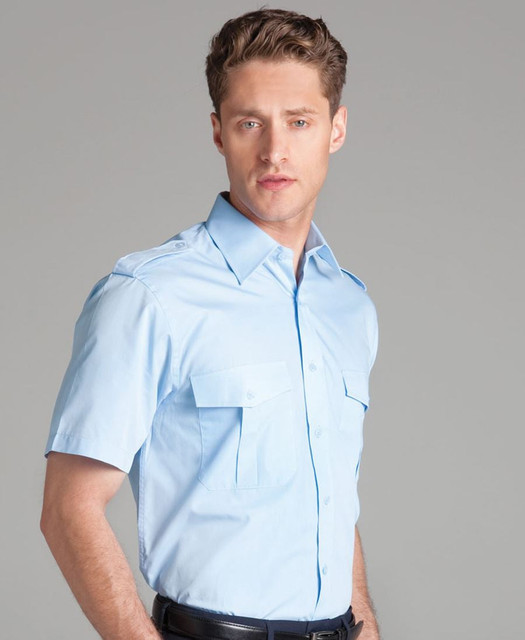 A short-sleeved button-up shirt in light blue with two chest pockets and a logo on the collar.