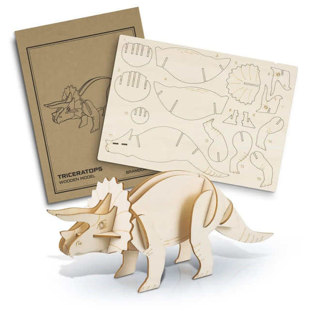 A wooden model of a triceratops in natural wood colour, with a template sheet and design outline behind it.