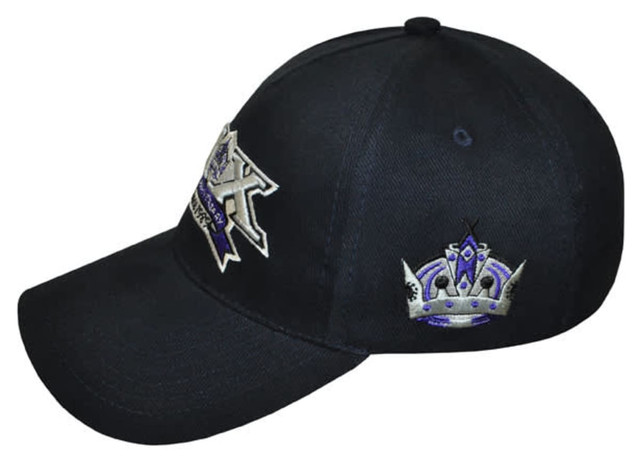 A black cap featuring an embroidered design with a crown and a logo.