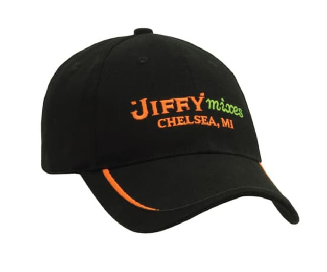 A black cap featuring green and orange embroidery, with a logo and text on the front.