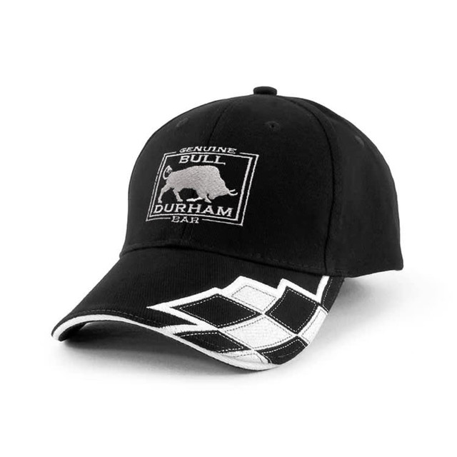 A black cap with a bull logo and a white patterned design on the peak. It features a branded emblem.