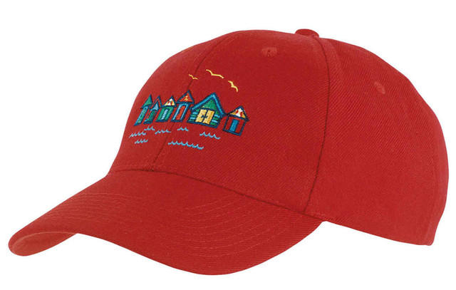A red college cap featuring an embroidered design of colourful houses and seagulls. It has a branded logo.
