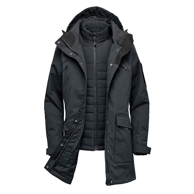 A dark green women's jacket with a removable inner layer and hood, featuring multiple pockets and a branding logo.