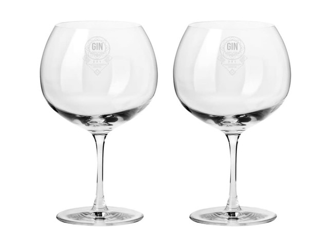 A set of two clear glass gin balloon glasses in a gift box, featuring a logo on each glass.