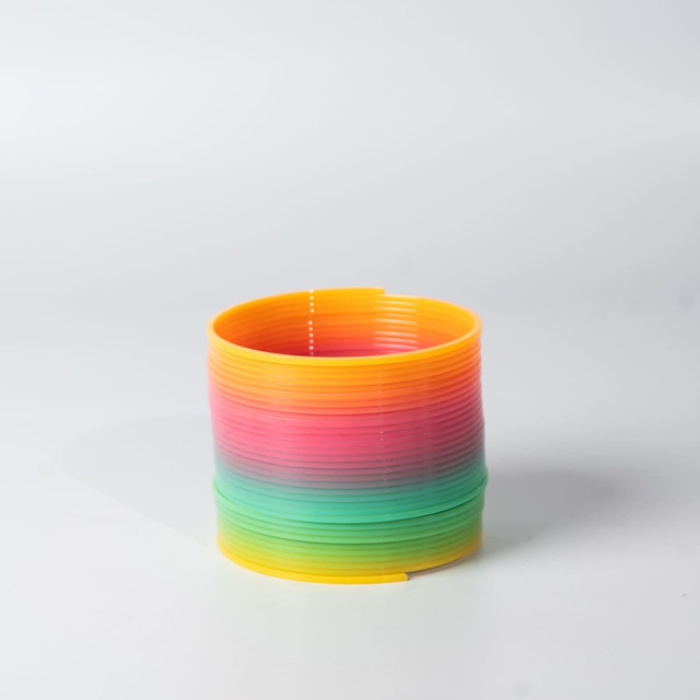 A drink bottle in vibrant rainbow colours, featuring a blend of yellow, pink, and green, with a circular design.