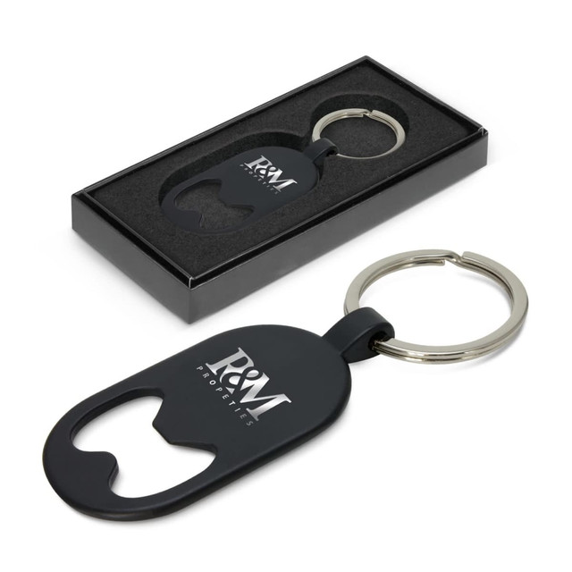 A drink bottle opener key ring in black, presented in a black box, featuring a logo.