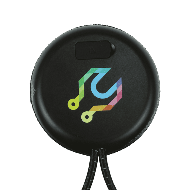 A round black Bluetooth speaker with a multicoloured logo, featuring a textured surface and a loop for attachment.