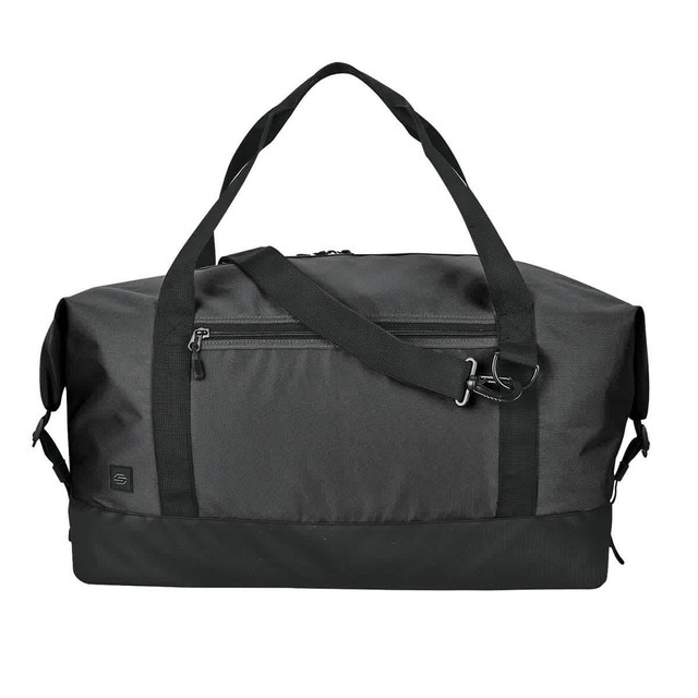A black duffle bag with dual handles, a detachable shoulder strap, and a zippered front pocket. Features a logo.