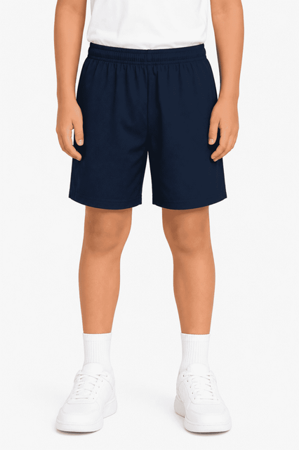 Navy school kids' sports shorts with an elastic waistband, modelled by a child wearing white shoes.