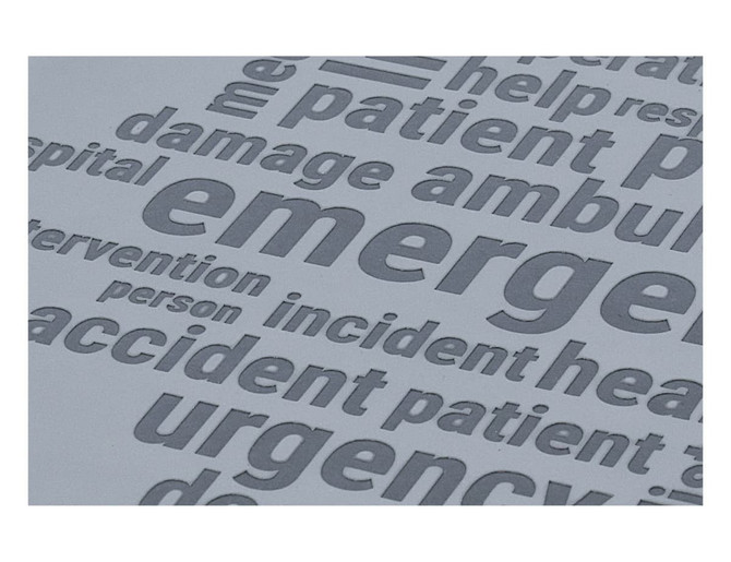 A grey notebook featuring debossed words related to emergency services and healthcare. It has a branded logo.