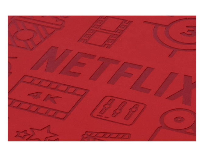 A red notebook cover features debossed design elements related to film and streaming. It includes a branding logo.