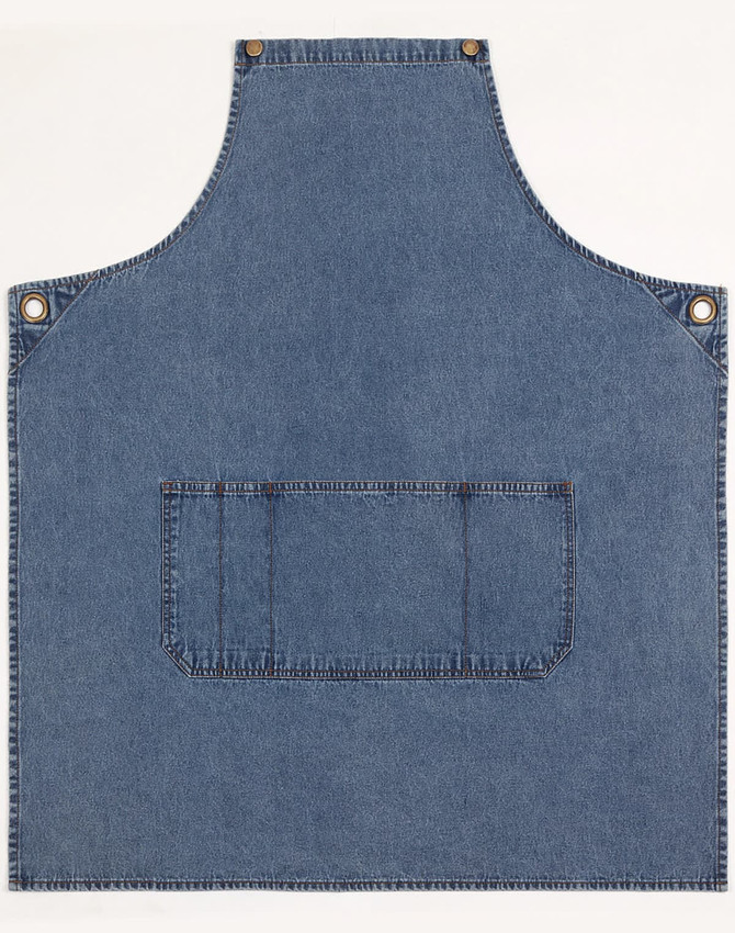 Denim bib apron in blue with a front pocket and metal snaps, featuring a logo.