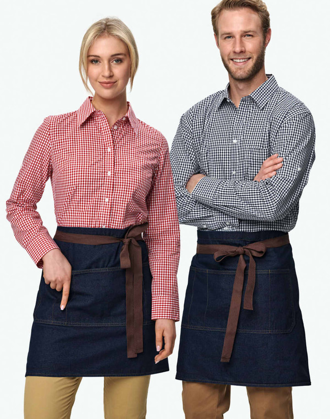 Denim half aprons in dark blue featuring brown ties, displayed on a male and female model wearing checkered shirts.