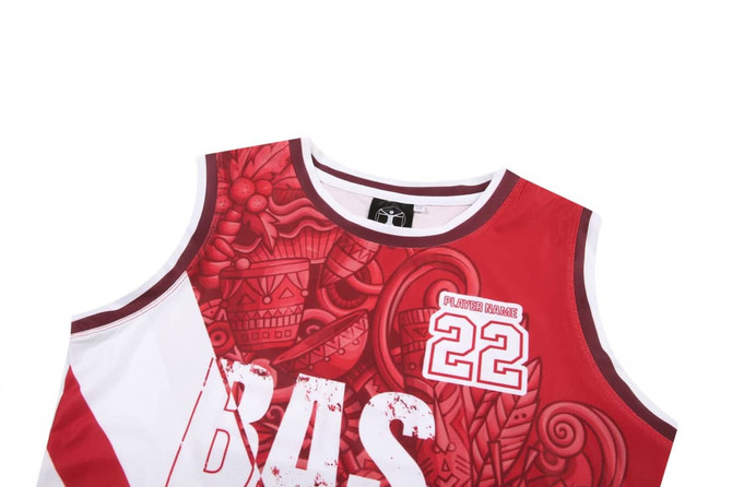 A women's basketball singlet in red and white with a decorative design and a logo on the label.