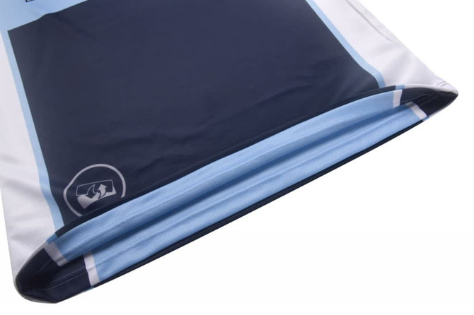 A reversible basketball top in navy blue and light blue, featuring a logo at the hem.