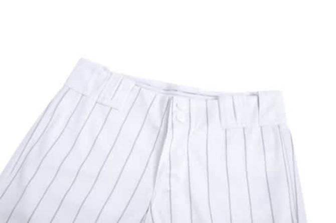 A white baseball uniform featuring vertical pinstripes, with a button closure and waistband. It includes a logo.