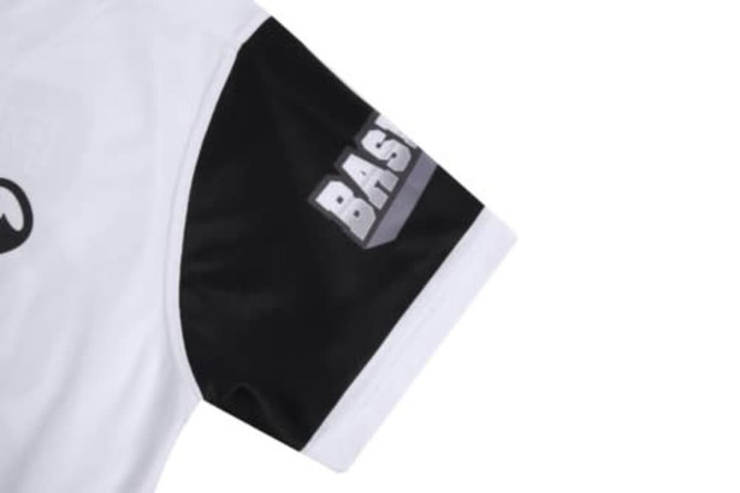 A white and black sports jersey featuring a predominantly white body and black sleeves. The sleeve has a logo.