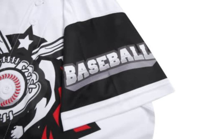 A white baseball jersey features a black sleeve with a logo and graphic design elements in red and grey.