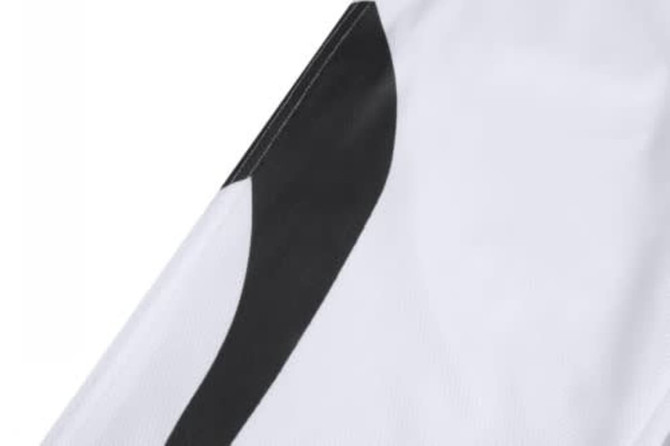 A white sports jersey featuring black design details and a logo on the fabric.