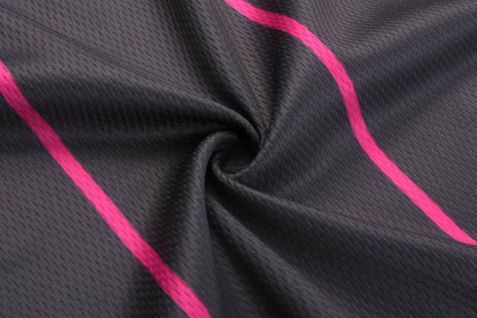 A black fabric featuring a textured pattern with vibrant pink stripes. It has a smooth, flowing appearance.