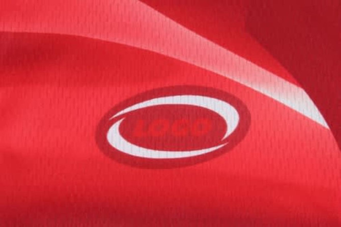 A vibrant red cycling jersey featuring a logo, made from breathable fabric with a textured finish.