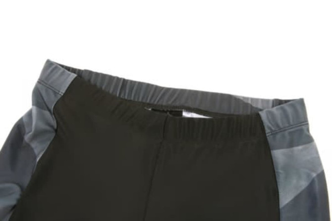 A cycling uniform in dark green with grey detailing, featuring a comfortable elastic waistband and a sleek design.