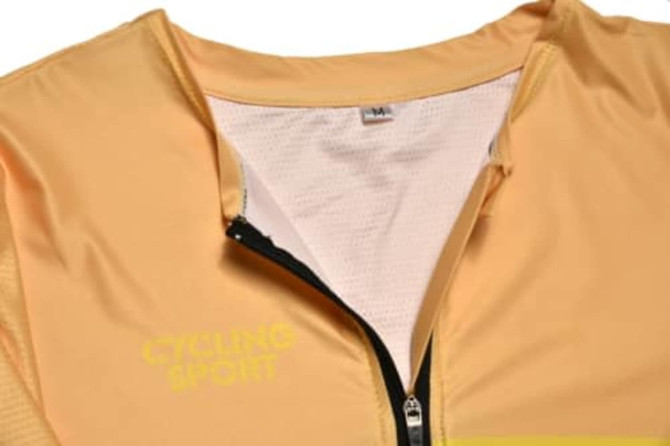 A cycling jersey in a vibrant yellow hue features a zippered front and a mesh inner lining, with a logo present.