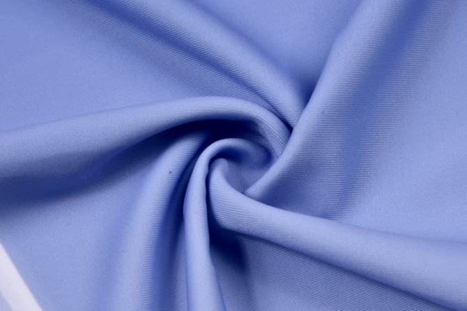 A light blue fabric showcasing a smooth, stretchy texture suitable for activewear. The material has a subtle sheen.