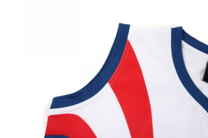 A sports jersey featuring a white base with red and blue accents, and a logo on the neckline.