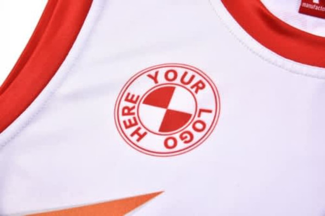 A white sports jersey featuring red accents and a logo on the chest area.