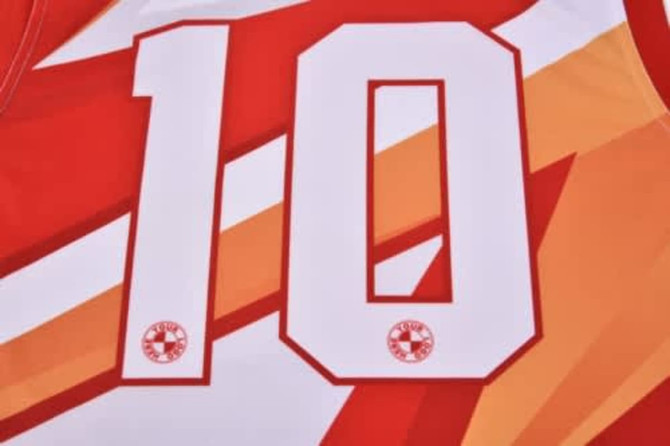 A red and orange sports jersey featuring the number 10, with a logo on the fabric.