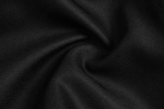 A close-up of black fabric, showcasing a smooth, textured surface with a slight sheen.