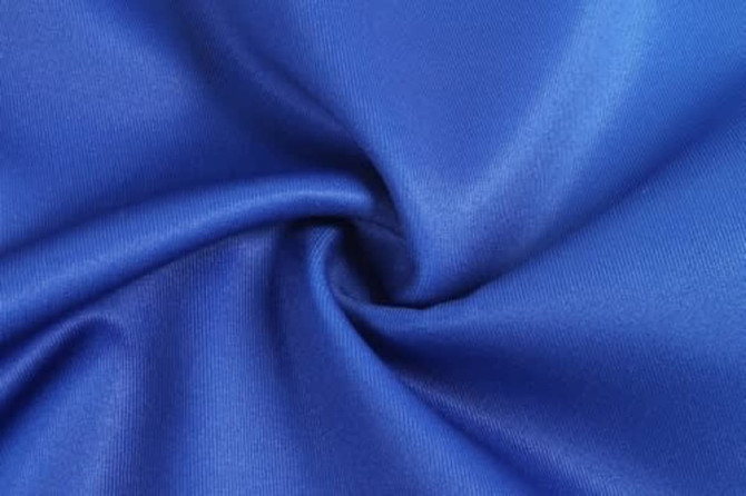 A smooth, vibrant blue fabric, showcasing a lustrous texture suitable for sports uniforms.