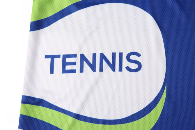A blue and green tennis team uniform featuring a logo and text design, suitable for sports activities.