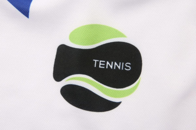 A close-up of a fabric featuring a tennis-themed logo in black and green on a white background.