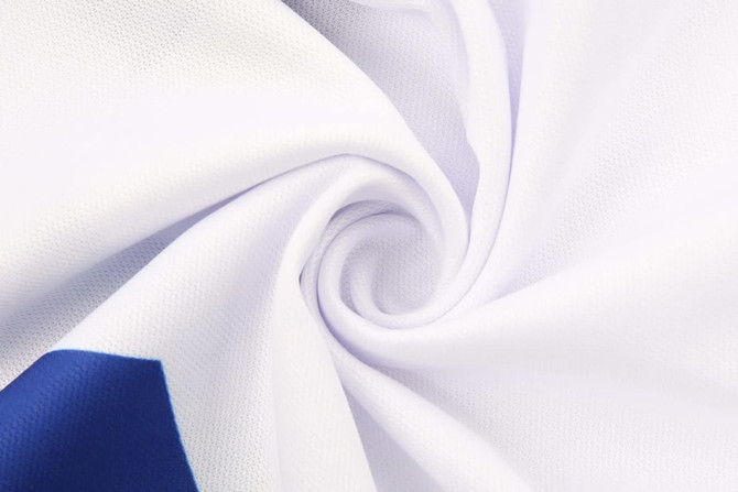 A close-up of white fabric, featuring smooth, athletic material with a blue detail and logo.