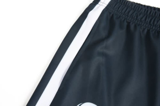 A sports uniform featuring dark navy fabric with white side stripes and a logo.