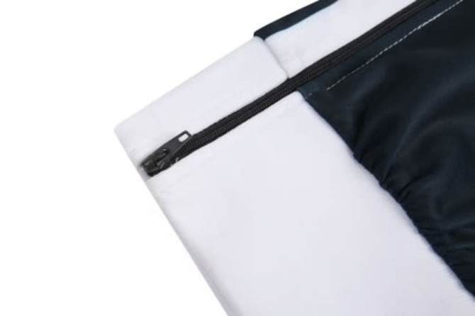 A close-up of a cricket team wear jersey featuring a black and white design with a zip. It has a logo on the fabric.