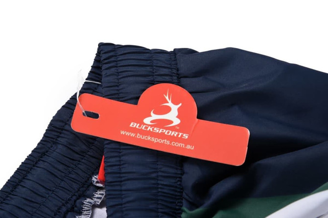 A close-up of a navy blue sports uniform featuring green stripes and a tag with a logo.