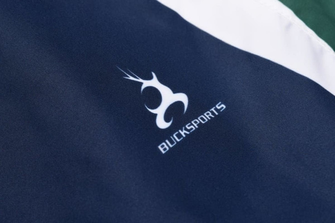 A navy and white sports uniform featuring a logo. The fabric has a smooth texture, ideal for outdoor activities.