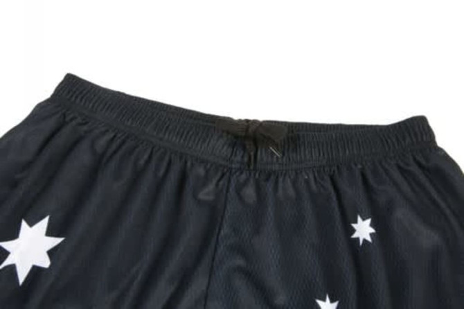 Black sports shorts featuring white star patterns and an elastic waistband. Includes a logo or branding element.