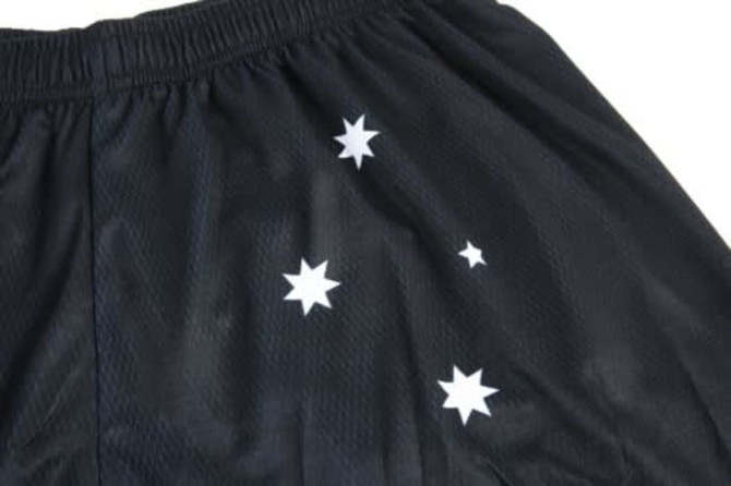 Black sports shorts with a mesh texture featuring white star designs scattered across the fabric.