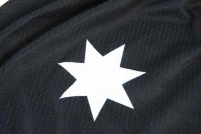 A black sports jersey featuring a white star logo. The fabric has a textured pattern.