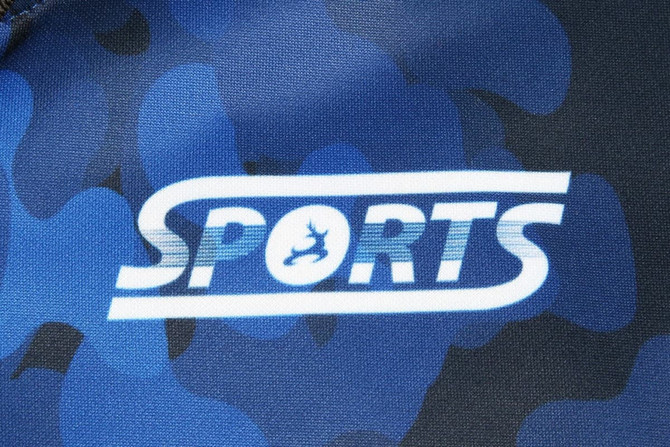 A blue and black camouflaged fabric featuring a logo with the word "SPORTS."
